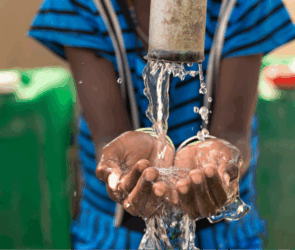 A file photo of a child's hands taking water from a tap