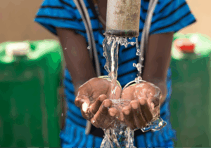 A file photo of a child's hands taking water from a tap